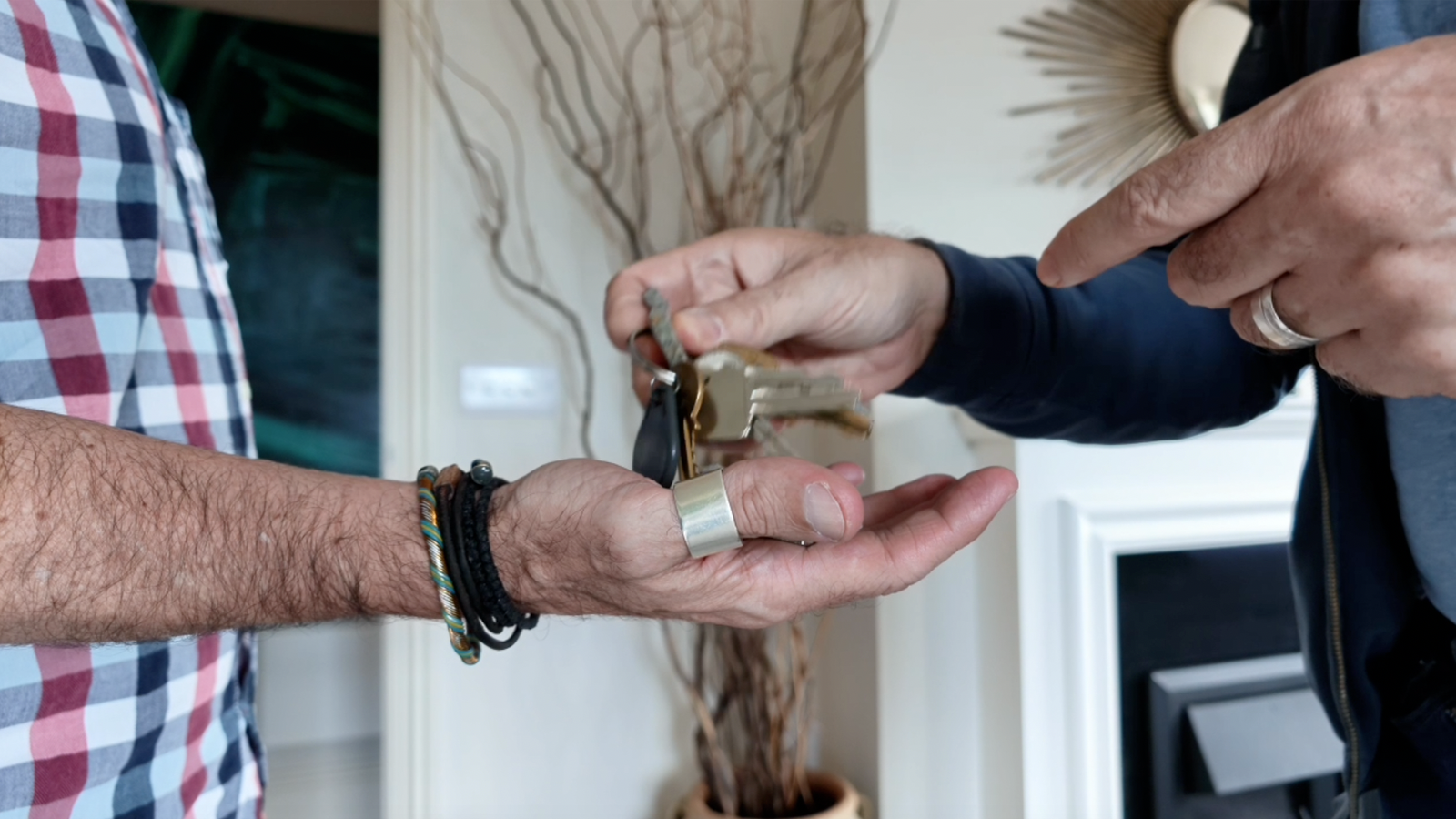 James and Rob handing a set of house keys to a trusted keyholder